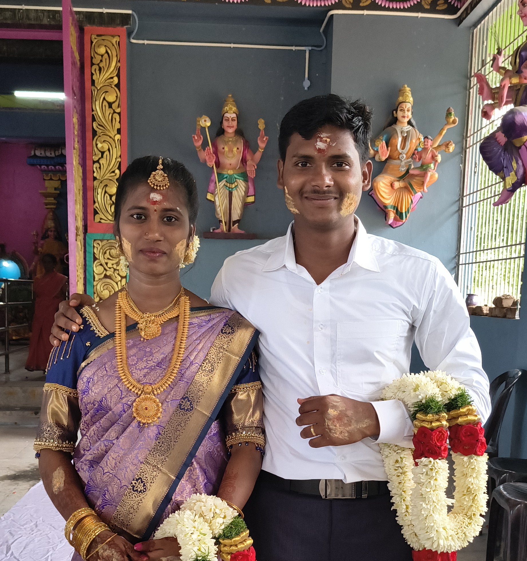 Pushpa and Hariharan garlanded, traditional wedding attire